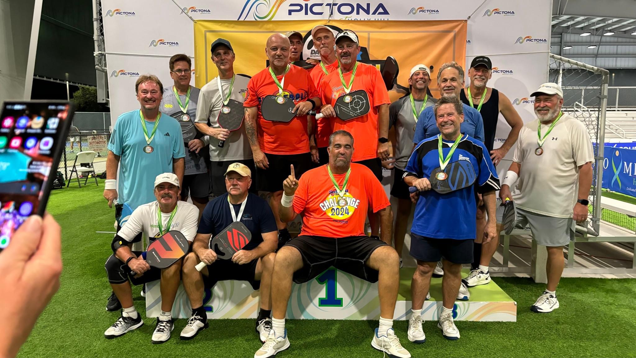 4.0 level 50+ age Medal stand group picture