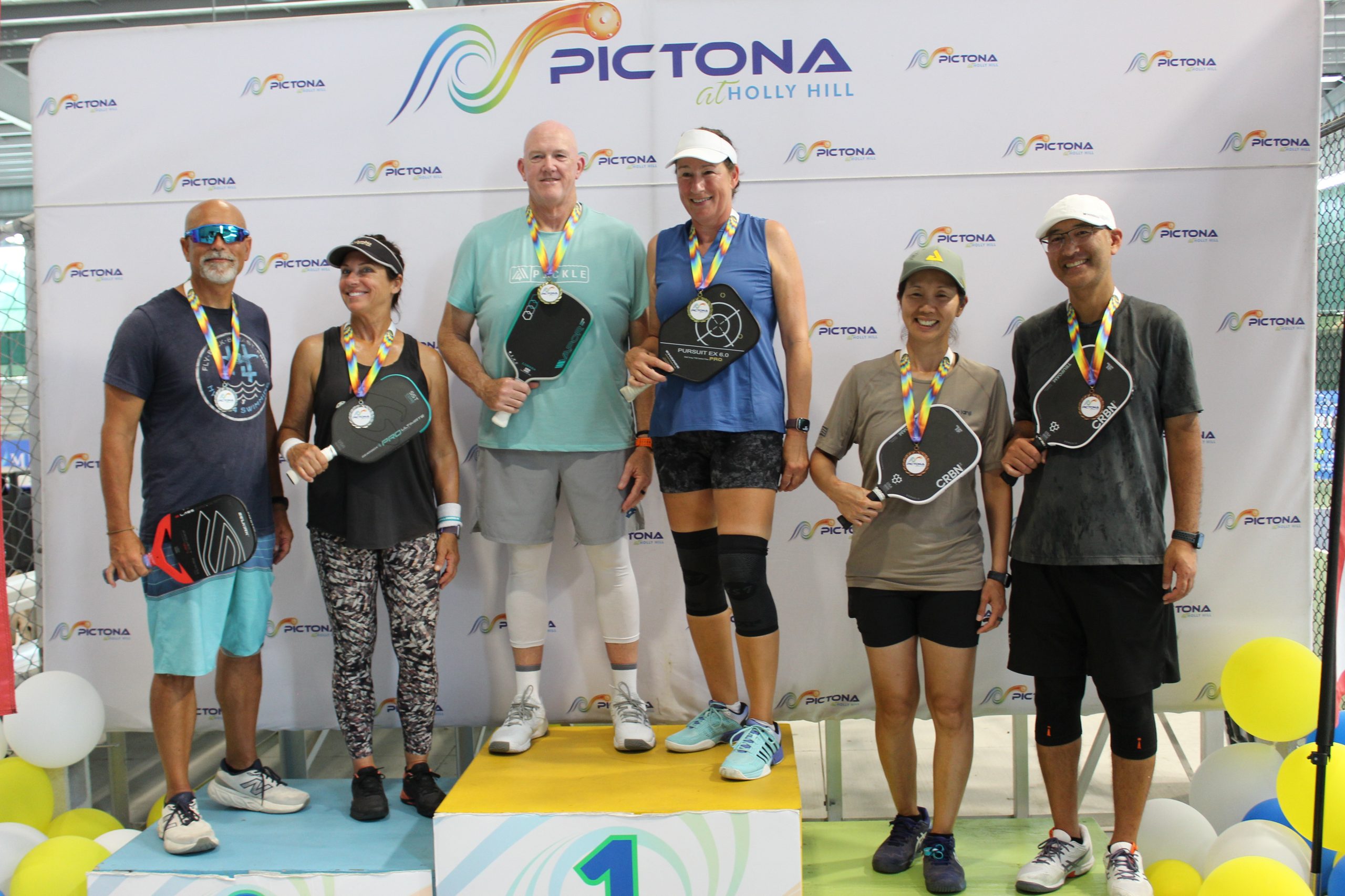 Metro Health Super Seniors 2025 Mixed Doubles medal stand - Rainer's Sister-in-law